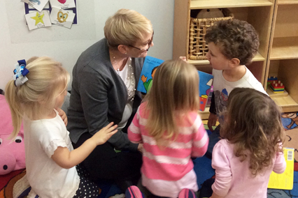 Jessica Shields Flowers, parenting coach, reads to children in a classroom